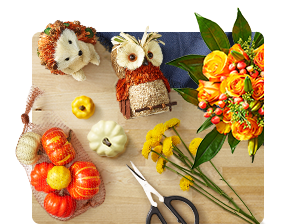 Rustic fall critter and pumpkin decorations with floral arrangement.