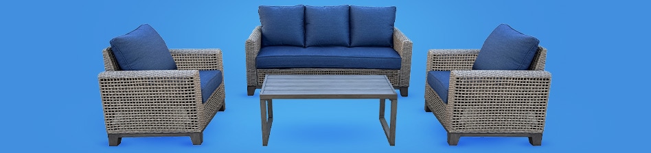 Perfect your patio with a gray wicker patio set, with two chairs, a table, and love seat with blue cushions on a blue background.