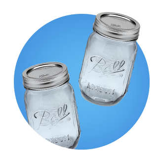 Two clear Ball mason jars on a blue background. 