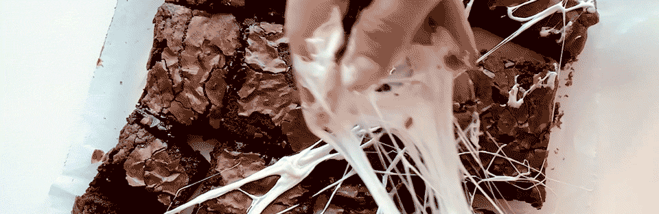 Marshmallows being pulled to look like spider webs