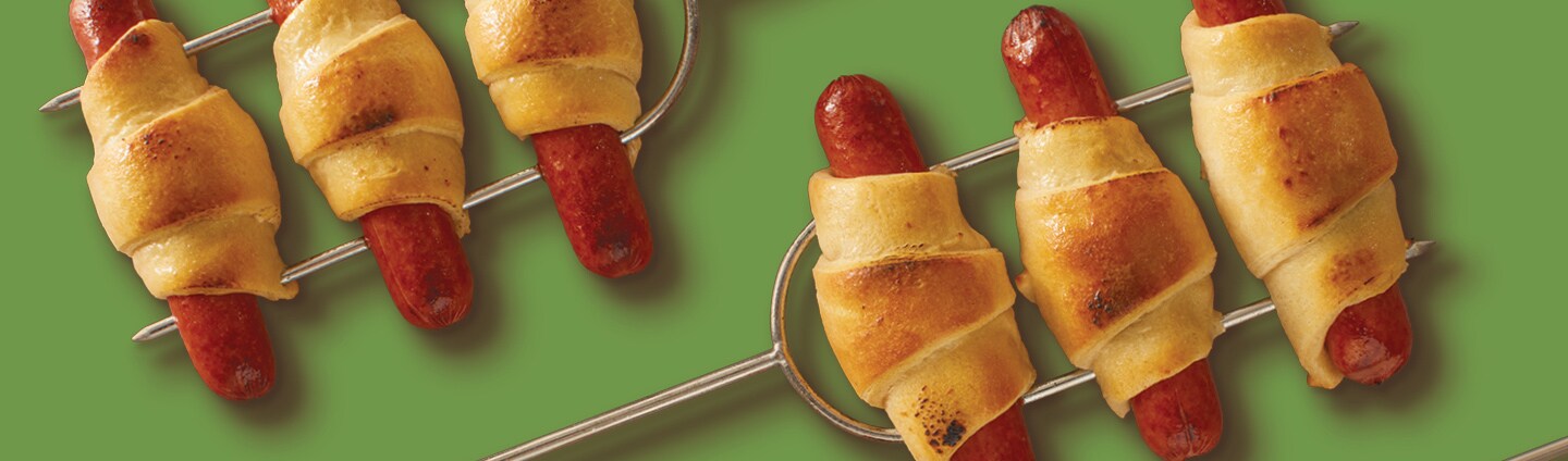 campfire skewers of pigs in a blanket