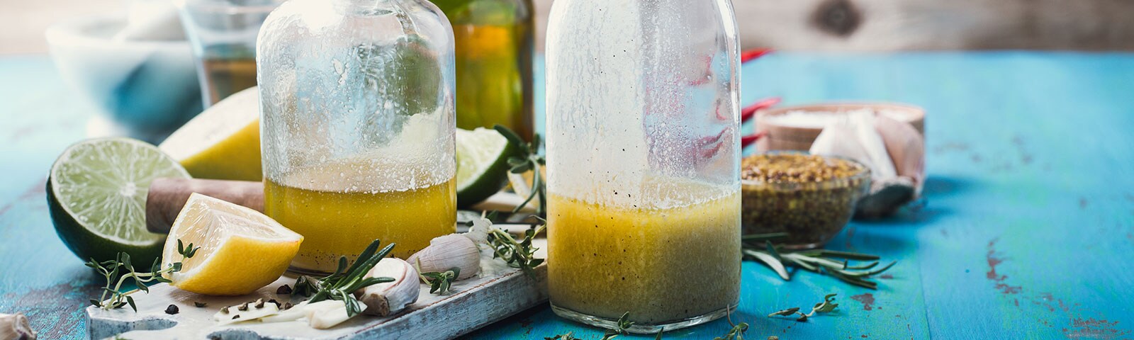 Two milk bottles filled with salad dressing