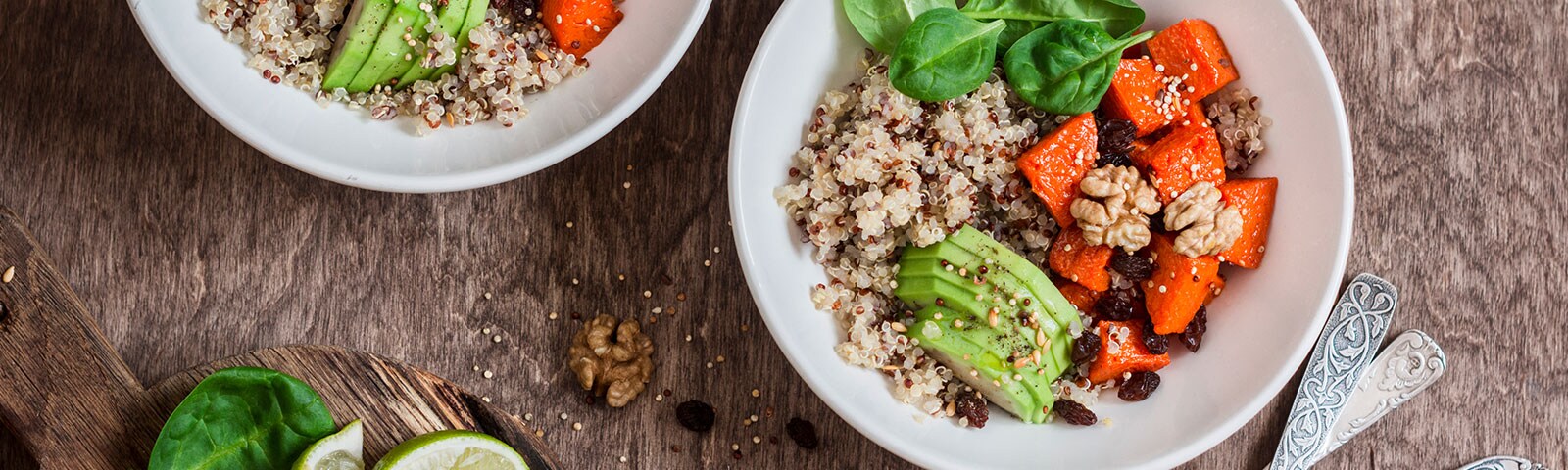Quinoa bowls with avocado on a wooden table