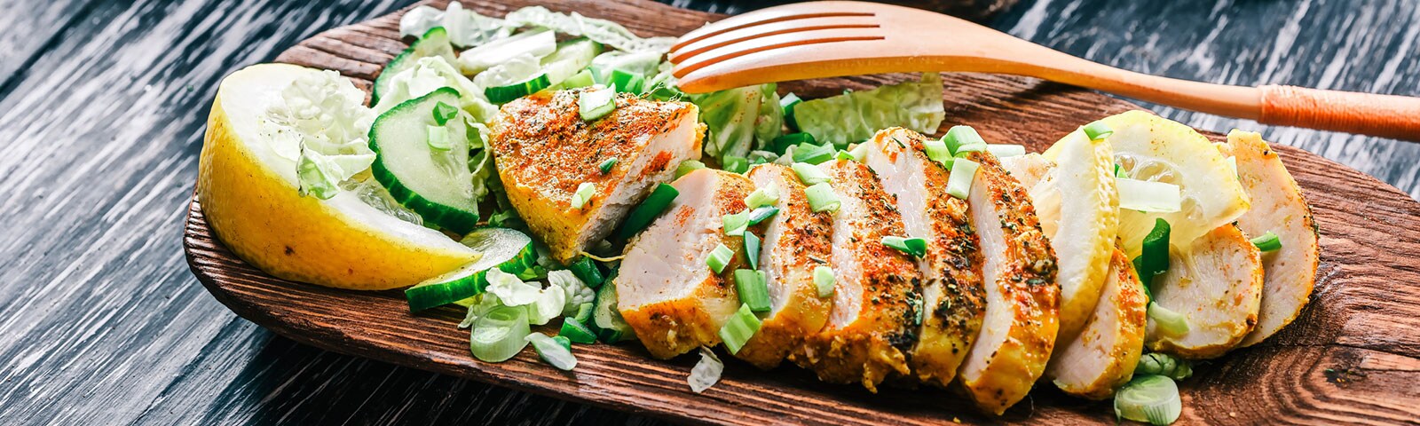 Chicken and vegetable on a wooden platter Chicken and vegetable on a wooden platter