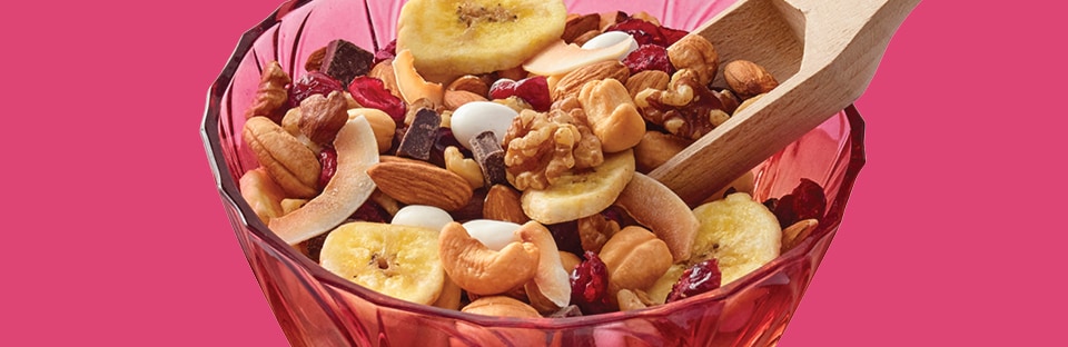 Trail mix with dried fruit, assorted nuts, toasted coconut flakes, chocolate and raisins.