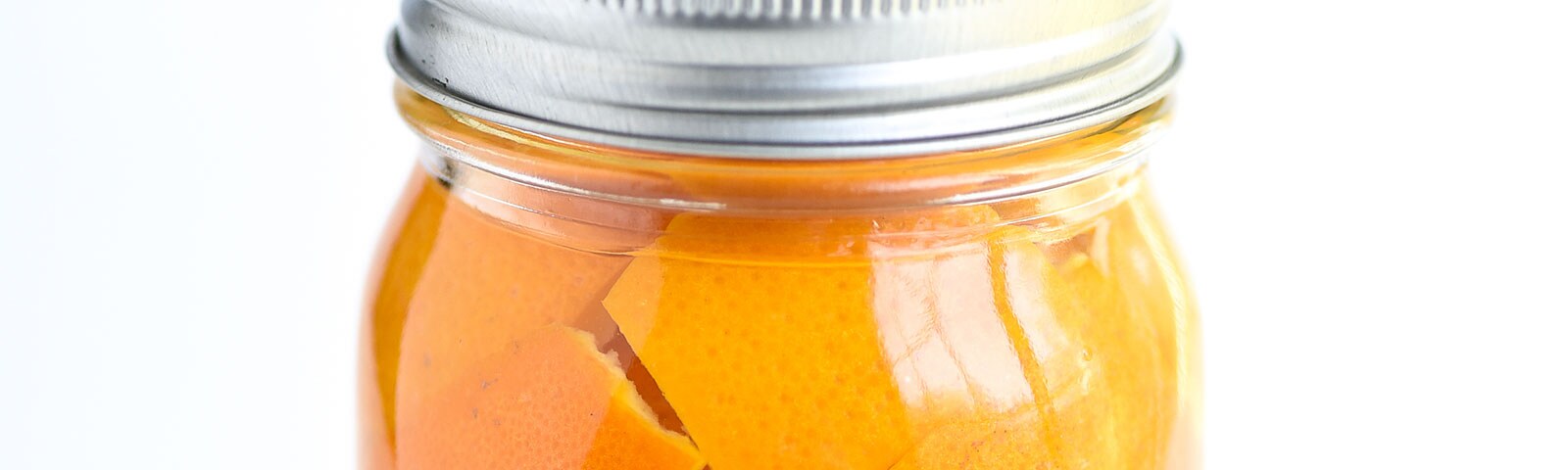 A mason jar filled with orange peels A mason jar filled with orange peels
