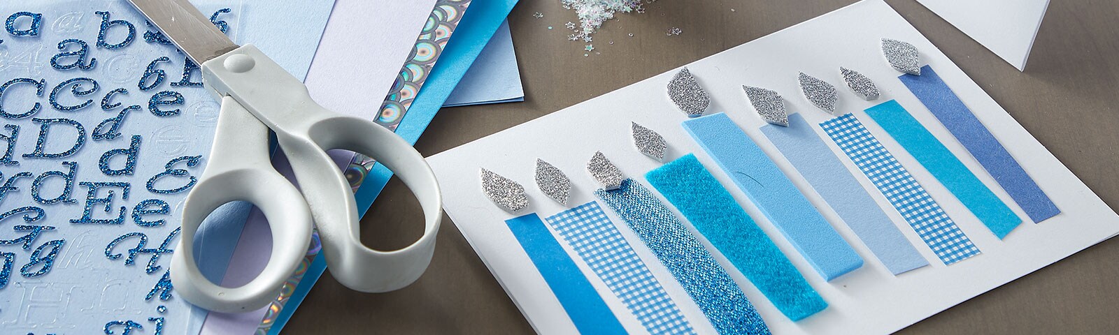 White and blue colored paper  in shapes of candles and cards