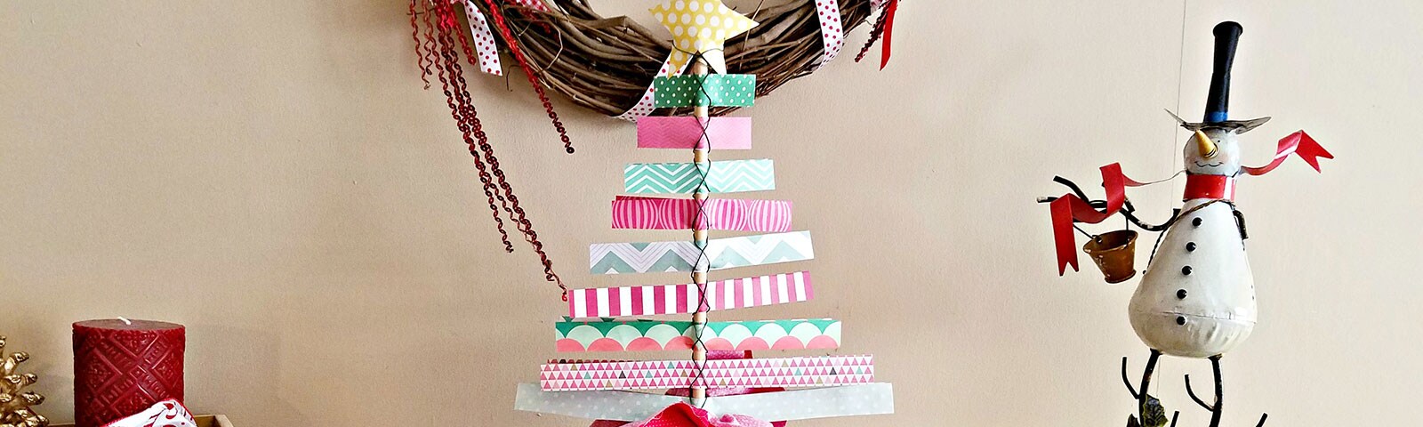 Scrapbook paper made into a Christmas tree standing on a table