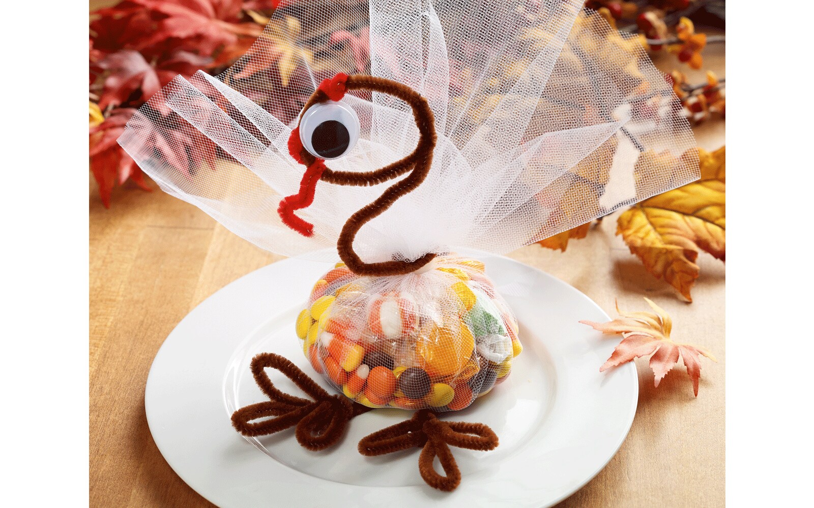 A turkey with a candy body wrapped in tulle, pipe cleaners for legs, and a pipe cleaner neck and head with googly eyes A turkey with a candy body wrapped in tulle, pipe cleaners for legs, and a pipe cleaner neck and head with googly eyes