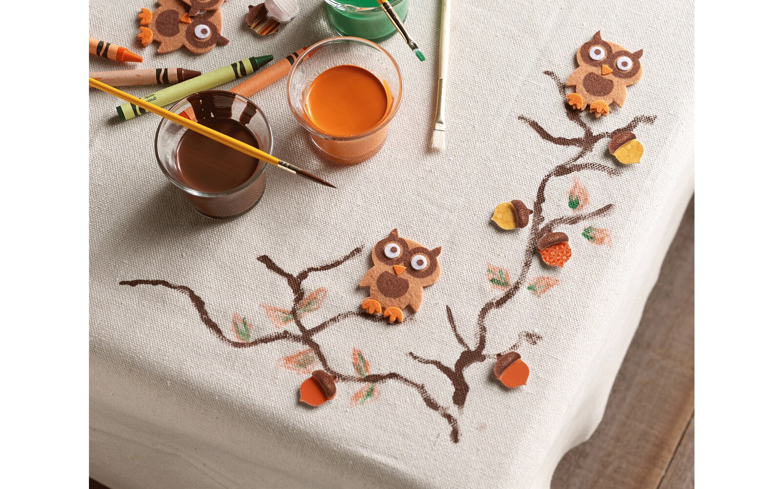 Table cloth with paint brushes and owls