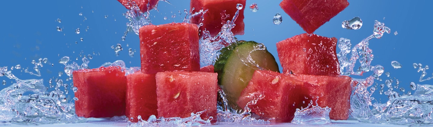 fresh watermelon cubes and cucumber slices with splashes of water